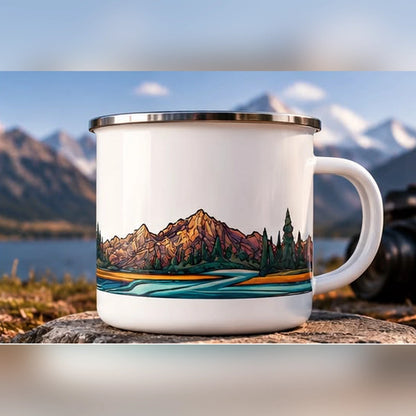 Mountain landscape enamel mug with illustrated alpine peaks, evergreen forest and turquoise river, front-right handle angle