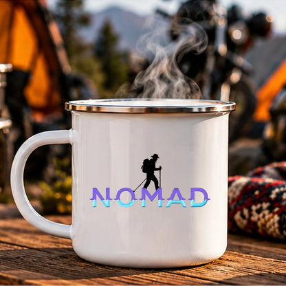 Reverse side of Nomad enamel camping mug with matching original hiker silhouette and gradient lettering at a mountain campsite