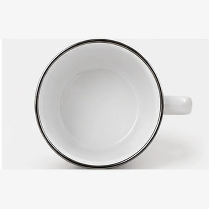 Top view of empty white Nomad enamel camping mug showing its white interior and silver stainless steel rim