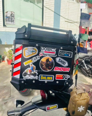 Motorcycle with various stickers on a stand outdoors