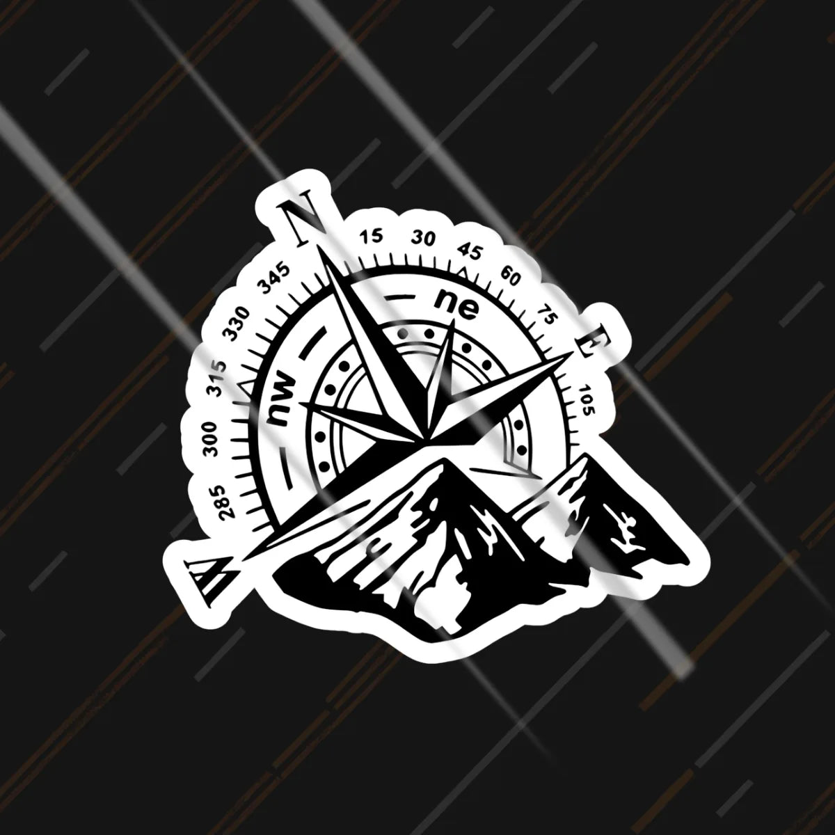 Compass and mountains reflective sticker 3 inch glowing under headlights at night