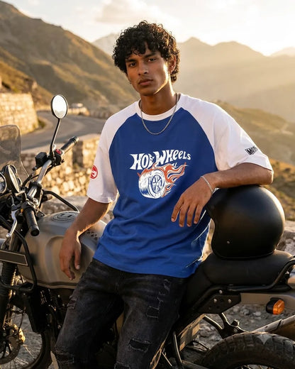 Hot Wheels blue raglan T-shirt worn beside a motorcycle