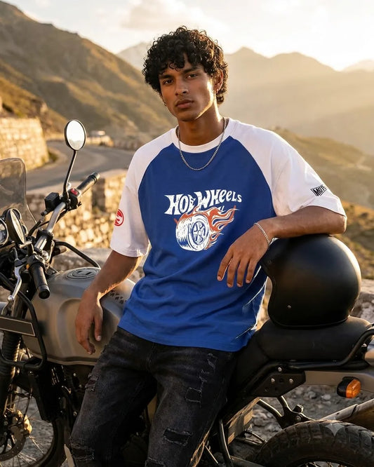 Hot Wheels blue raglan T-shirt worn beside a motorcycle