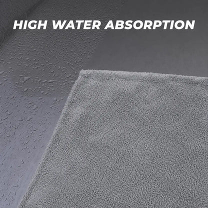Grey microfiber cloth absorbing water off a wet car panel – Motohomies