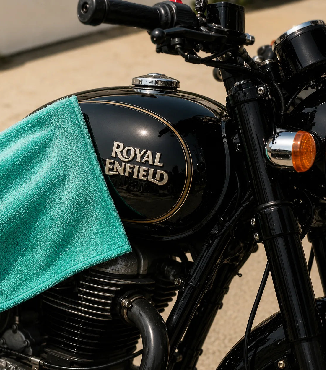 Aqua 1200 GSM microfiber cloth drying a black Royal Enfield fuel tank – Motohomies