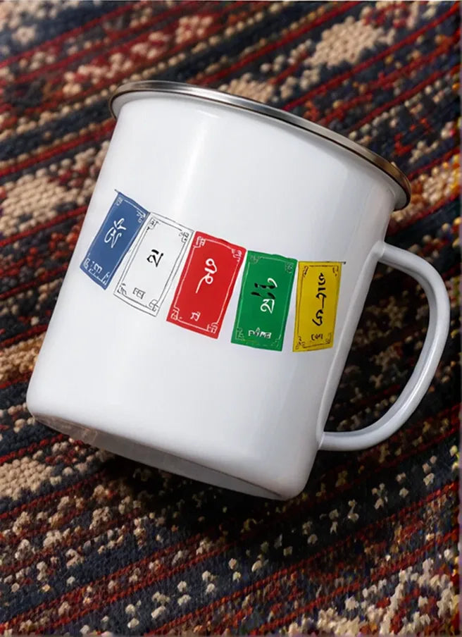 Om Mani Padme Hum enamel mug with prayer flag design on a traditional woven rug