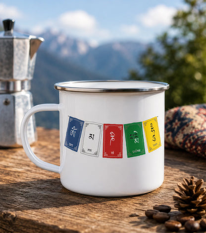 Om Mani Padme Hum enamel camping mug on a wooden table with Himalayan mountains and moka pot