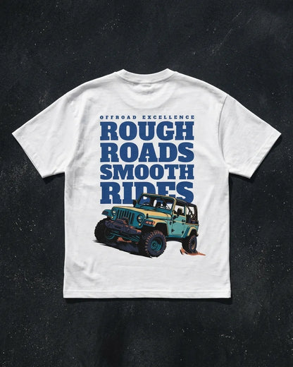 Rough Roads Smooth Rides white oversized t-shirt flat lay showing back print with Jeep design on dark concrete