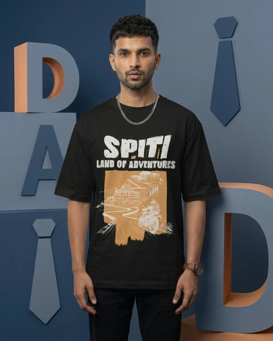 Spiti Land of Adventures black oversized t-shirt on male model with monastery and bike graphic