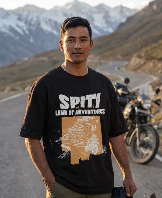 Spiti Land of Adventures black oversized t-shirt worn by rider with Royal Enfield Himalayan in Spiti mountains