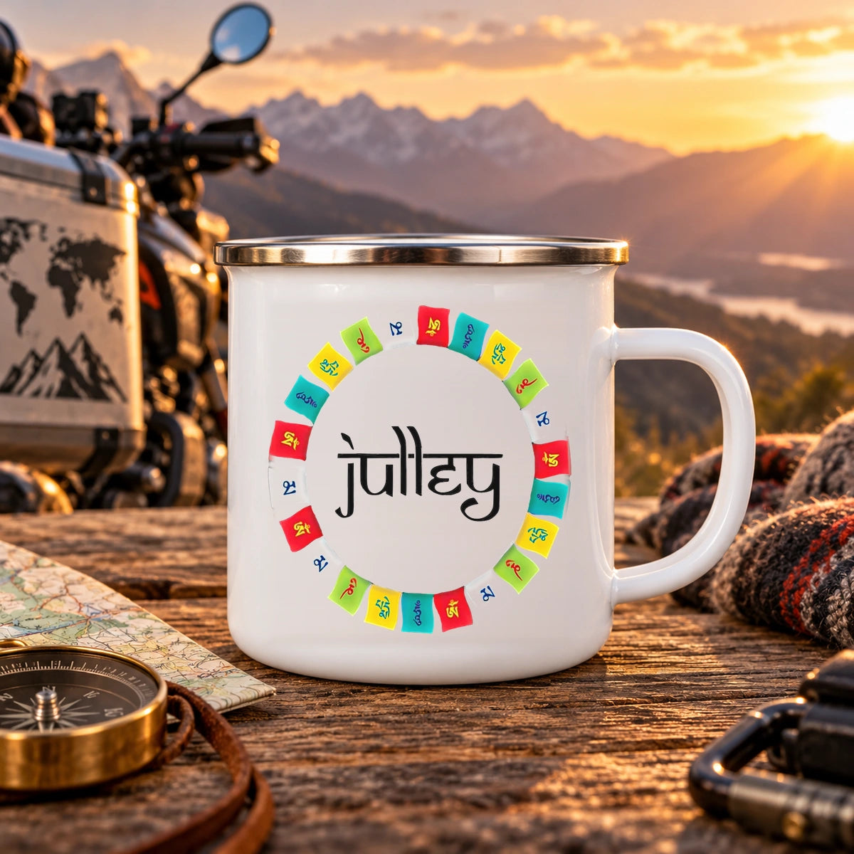 Spiti prayer flags enamel camping mug with black Devanagari lettering and colourful Himalayan flags at golden-hour mountain campsite