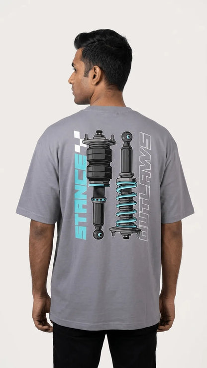 Indian male model wearing Stance Outlaws coilover tee back view, oversized drop-shoulder biker streetwear